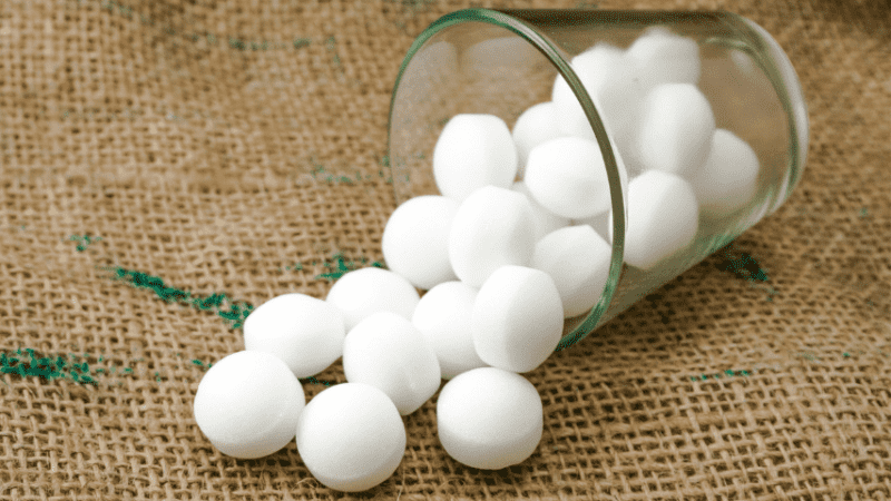 Mothballs are a pesticide with a strong, sweet odor and a ball-like shape